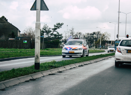 Papendrecht Netherlands March 12, 2019 View of a Duch police car rolling in the streets of Papendrecht in the afternoonのeditorial素材