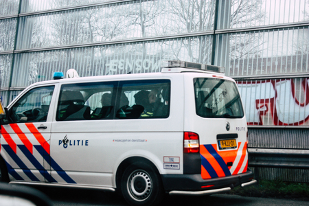 Rotterdam Netherlands March 18, 2019 View of a Dutch police car rolling in the highway in the afternoonのeditorial素材