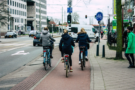 Voorburg Netherlands March 26, 2019 View of unknown Dutch people with a bicycle in the streets of Voorburg in the afternoonのeditorial素材