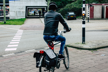 Voorburg Netherlands March 26, 2019 View of unknown Dutch people with a bicycle in the streets of Voorburg in the afternoonのeditorial素材