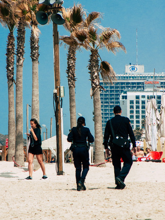 Tel Aviv Israel March 26, 2019 View of unknown Israeli police officer walking on the beach of Tel Aviv in the afternoonのeditorial素材