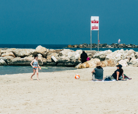 Tel Aviv Israel March 26, 2019 View of unknown Israeli kid having fun on the beach of Tel Aviv in the afternoonのeditorial素材