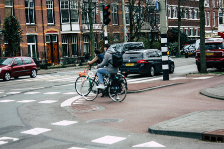 Voorburg Netherlands March 26, 2019 View of unknown Dutch people with a bicycle in the streets of Voorburg in the afternoonのeditorial素材