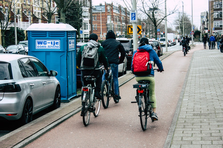 Voorburg Netherlands March 26, 2019 View of unknown Dutch people with a bicycle in the streets of Voorburg in the afternoonのeditorial素材