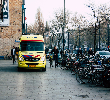 Rotterdam Netherlands April 1, 2019 View of a Dutch yellow ambulance parked in the streets of Rotterdam in the afternoonのeditorial素材