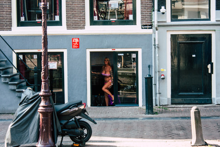 Amsterdam Netherlands April 8, 2019 View of the facade of a old Dutch building located in the Red Light quarter in Amsterdam in the eveningのeditorial素材