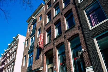 Amsterdam Netherlands April 8, 2019 View of the facade of a old Dutch building located in the Red Light quarter in Amsterdam in the eveningのeditorial素材