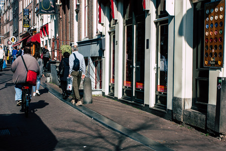 Amsterdam Netherlands April 8, 2019 View of unknowns people walking in the Red Light district in Amsterdam in the eveningのeditorial素材