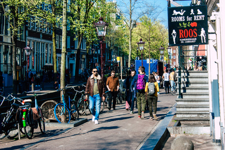 Amsterdam Netherlands April 8, 2019 View of unknowns people walking in the Red Light district in Amsterdam in the eveningのeditorial素材
