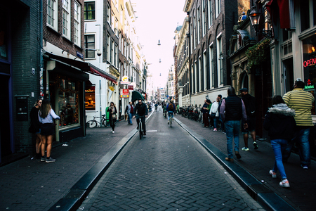 Amsterdam Netherlands April 8, 2019 View of unknowns people walking in the Red Light district in Amsterdam in the eveningのeditorial素材
