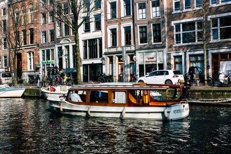 Amsterdam Netherlands April 8, 2019 View of a boat in the canals at the red light district of Amsterdam in the eveningのeditorial素材