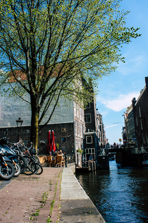 Amsterdam Netherlands April 8, 2019 View of old Dutch houses built along the canals in the red light district of Amsterdam in the eveningのeditorial素材