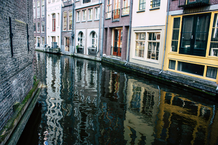 Amsterdam Netherlands April 8, 2019 View of old Dutch houses built along the canals in the red light district of Amsterdam in the eveningのeditorial素材