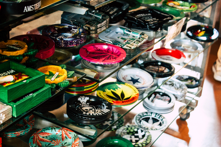 Closeup of decorative objects about cannabis sold in a traditional souvenirs shop at the Red Light district of Amsterdam in the morningの写真素材