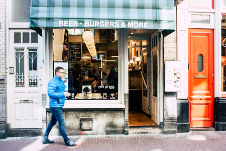 Amsterdam Netherlands April 10, 2019 View of unknown Dutch people walking in Nieuwe Hoogstraat street in Amsterdam in the eveningのeditorial素材