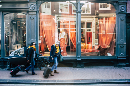 Amsterdam Netherlands April 10, 2019 View of unknown Dutch people walking in Nieuwe Hoogstraat street in Amsterdam in the eveningのeditorial素材