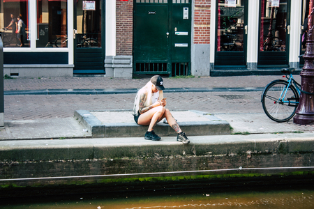 Amsterdam Netherlands April 10, 2019 View of the streets of Amsterdam in the old district near Central station in the eveningのeditorial素材