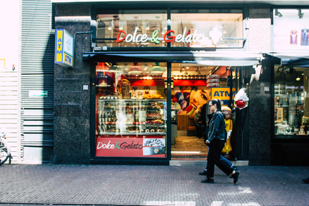 Amsterdam Netherlands April 10, 2019 View of unknown Dutch people walking in the streets of Amsterdam in the eveningのeditorial素材