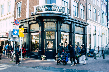 Amsterdam Netherlands April 10, 2019 View of unknown Dutch people walking in the streets of Amsterdam in the eveningのeditorial素材
