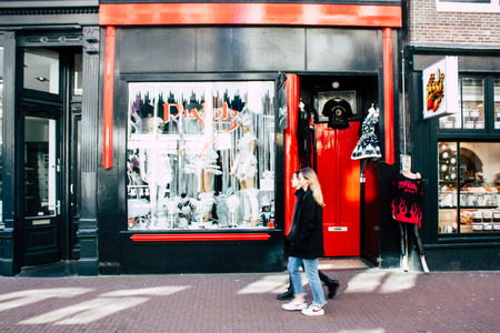 Amsterdam Netherlands April 10, 2019 View of unknown Dutch people walking in Nieuwe Hoogstraat street in Amsterdam in the eveningのeditorial素材