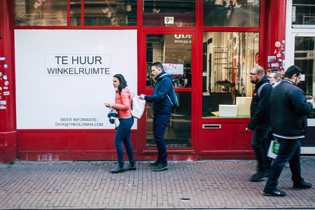 Amsterdam Netherlands April 10, 2019 View of unknown Dutch people walking in Nieuwe Hoogstraat street in Amsterdam in the eveningのeditorial素材