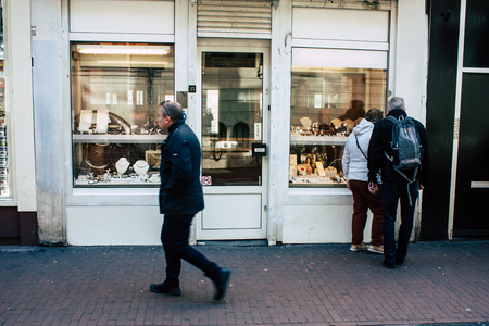 Amsterdam Netherlands April 10, 2019 View of unknown Dutch people walking in Nieuwe Hoogstraat street in Amsterdam in the eveningのeditorial素材