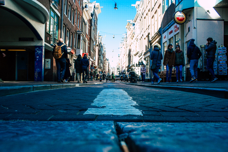 Amsterdam Netherlands April 10, 2019 View of unknown Dutch people walking in Nieuwe Hoogstraat street in Amsterdam in the eveningのeditorial素材