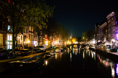 Amsterdam Netherlands April 15, 2019 View of old Dutch houses built along the canals in the red light district of Amsterdam in the nightのeditorial素材