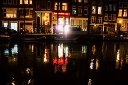 Amsterdam Netherlands April 15, 2019 View of old Dutch houses built along the canals in the red light district of Amsterdam in the nightのeditorial素材