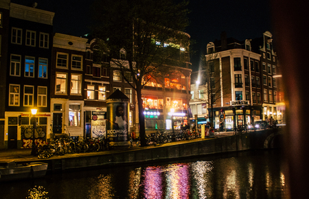 Amsterdam Netherlands April 15, 2019 View of old Dutch houses built along the canals in the red light district of Amsterdam in the nightのeditorial素材