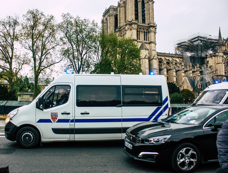Paris France April 16, 2019 View of a French police car parked near the Notre Dame cathedral in Paris the day after the big fire in the afternoonのeditorial素材