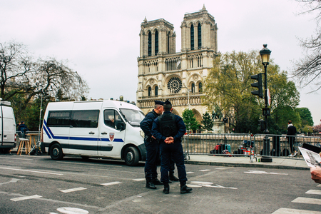Paris France April 16, 2019  View of police officers who secure the street front the Notre Dame cathedral which burned the day before in a big fire in the afternoonのeditorial素材