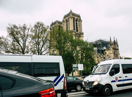 Paris France April 16, 2019 View of a French police car parked near the Notre Dame cathedral in Paris the day after the big fire in the afternoonのeditorial素材