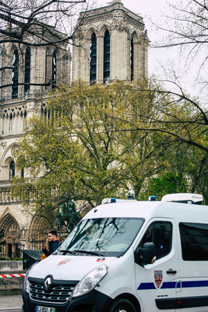 Paris France April 16, 2019 View of a French police car parked near the Notre Dame cathedral in Paris the day after the big fire in the afternoonのeditorial素材