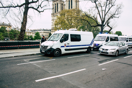 Paris France April 16, 2019 View of a French police car parked near the Notre Dame cathedral in Paris the day after the big fire in the afternoonのeditorial素材