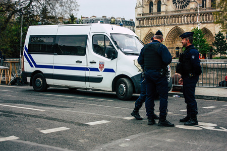 Paris France April 16, 2019  View of police officers who secure the street front the Notre Dame cathedral which burned the day before in a big fire in the afternoonのeditorial素材