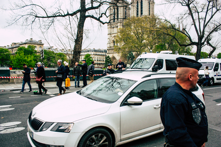 Paris France April 16, 2019  View of police officers who secure the street front the Notre Dame cathedral which burned the day before in a big fire in the afternoonのeditorial素材