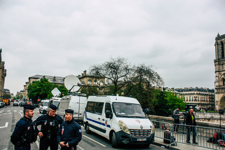 Paris France April 16, 2019  View of police officers who secure the street front the Notre Dame cathedral which burned the day before in a big fire in the afternoonのeditorial素材