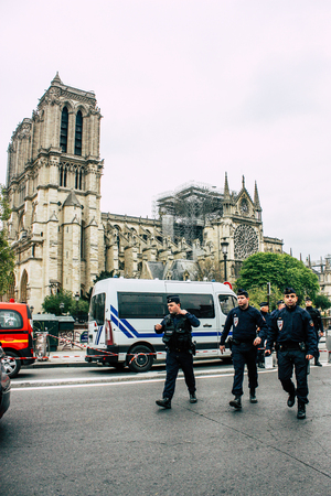 Paris France April 16, 2019  View of police officers who secure the street front the Notre Dame cathedral which burned the day before in a big fire in the afternoonのeditorial素材