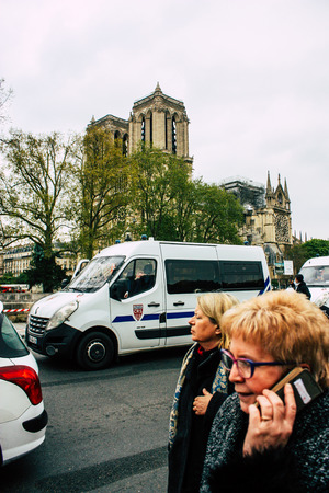 Paris France April 16, 2019 View of a French police car parked near the Notre Dame cathedral in Paris the day after the big fire in the afternoonのeditorial素材