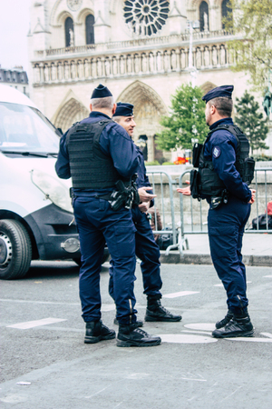 Paris France April 16, 2019  View of police officers who secure the street front the Notre Dame cathedral which burned the day before in a big fire in the afternoonのeditorial素材