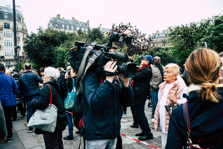 Paris France April 16, 2019  View of a journalist interviewing Parisians about the Notre Dame cathedral which burned the day before in a big fireのeditorial素材