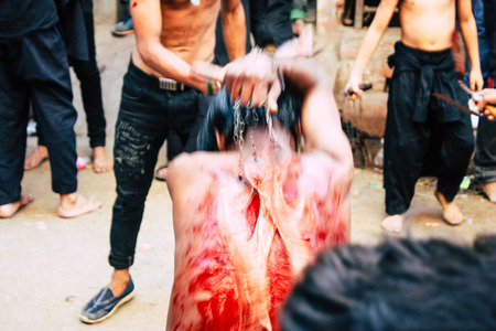 Varanasi India November 17, 2018 View of unknowns Shiite  Muslims use chains and blades during ritual self flagellation as part of the Imam Husain celebration, Ashura commemorations in the Arabian district of Varanasi in the morningのeditorial素材