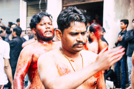 Varanasi India November 17, 2018 View of unknowns Shiite  Muslims use chains and blades during ritual self flagellation as part of the Imam Husain celebration, Ashura commemorations in the Arabian district of Varanasi in the morningのeditorial素材