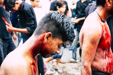 Varanasi India November 17, 2018 View of unknowns Shiite  Muslims use chains and blades during ritual self flagellation as part of the Imam Husain celebration, Ashura commemorations in the Arabian district of Varanasi in the morningのeditorial素材
