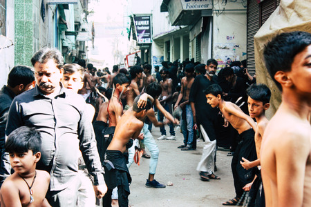 Varanasi India November 17, 2018 View of unknowns Shiite  Muslims use chains and blades during ritual self flagellation as part of the Imam Husain celebration, Ashura commemorations in the Arabian district of Varanasi in the morningのeditorial素材