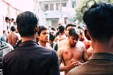 Varanasi India November 17, 2018 View of unknowns Shiite  Muslims use chains and blades during ritual self flagellation as part of the Imam Husain celebration, Ashura commemorations in the Arabian district of Varanasi in the morningのeditorial素材