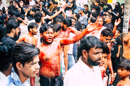 Varanasi India November 17, 2018 View of unknowns Shiite  Muslims use chains and blades during ritual self flagellation as part of the Imam Husain celebration, Ashura commemorations in the Arabian district of Varanasi in the morningのeditorial素材
