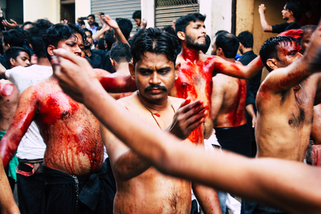 Varanasi India November 17, 2018 View of unknowns Shiite  Muslims use chains and blades during ritual self flagellation as part of the Imam Husain celebration, Ashura commemorations in the Arabian district of Varanasi in the morningのeditorial素材