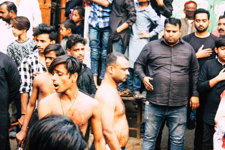 Varanasi India November 17, 2018 View of unknowns Shiite  Muslims use chains and blades during ritual self flagellation as part of the Imam Husain celebration, Ashura commemorations in the Arabian district of Varanasi in the morningのeditorial素材